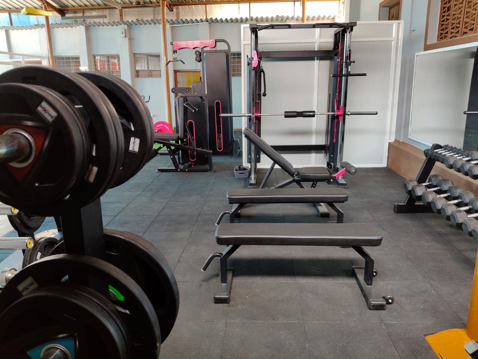 Free weights and benches arranged in the studio training zone.